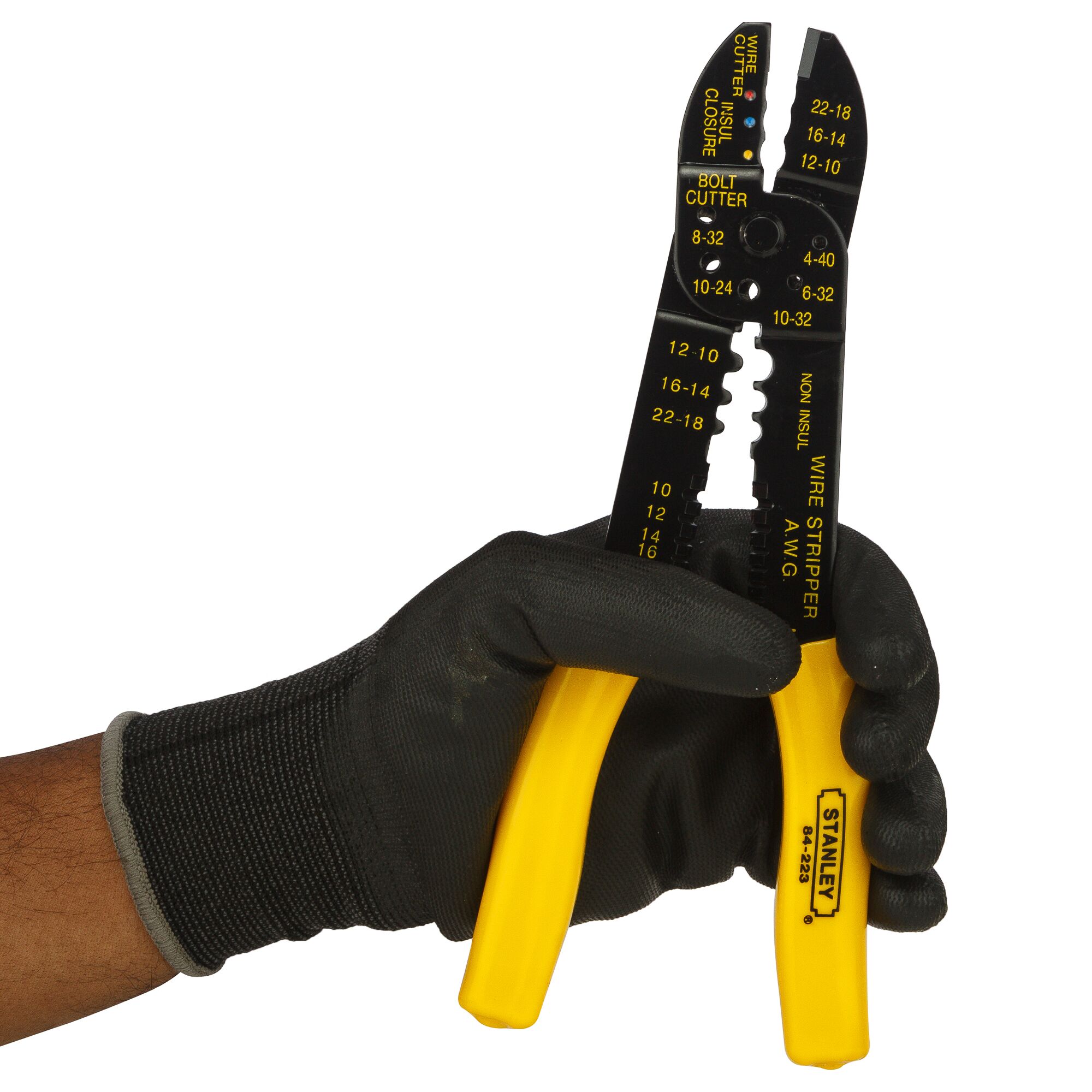 Stanley 84-223-22 wire stripper and cutter with yellow handles, front angle, held by gloved hand.