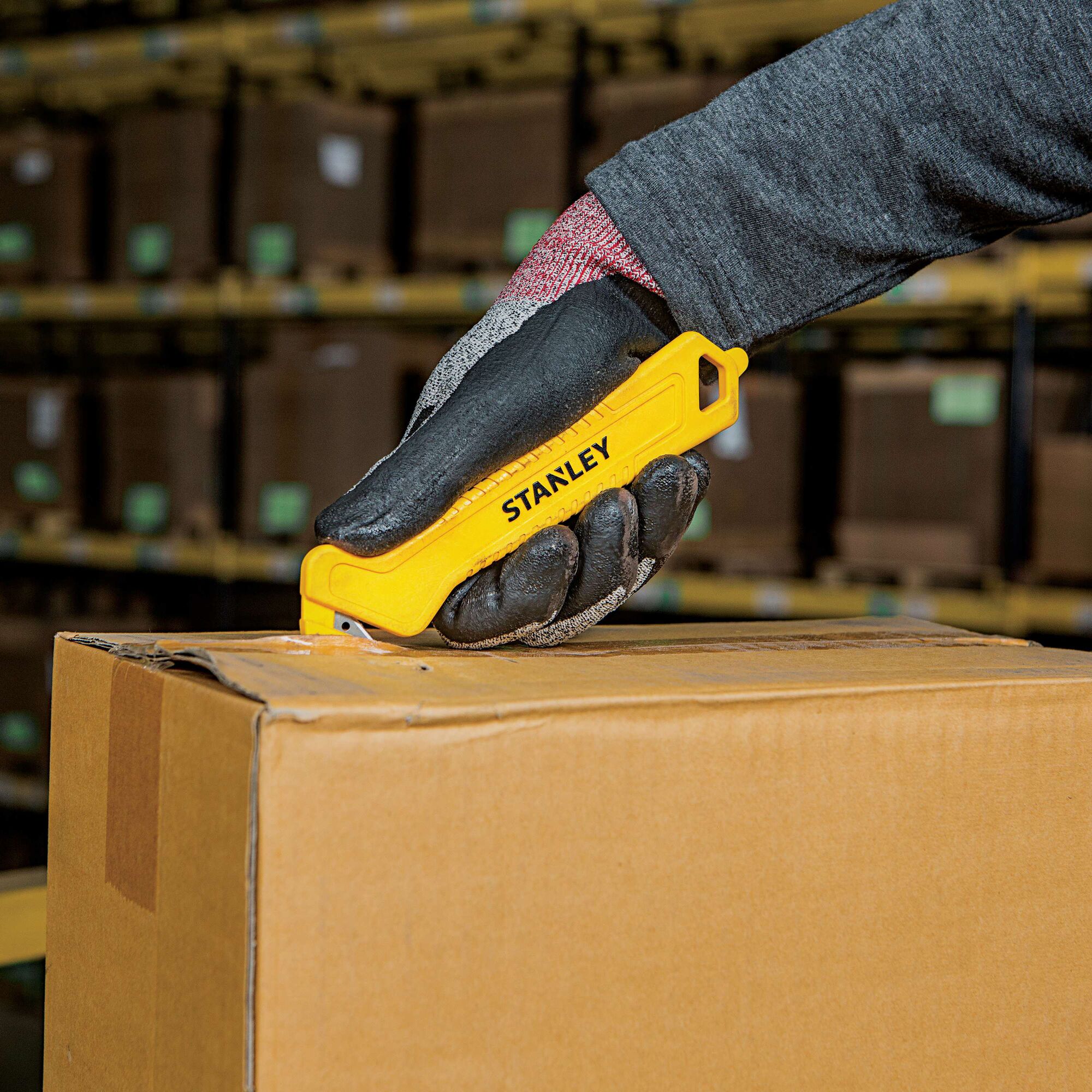 Single Sided Pull Cutter being used for opening package.