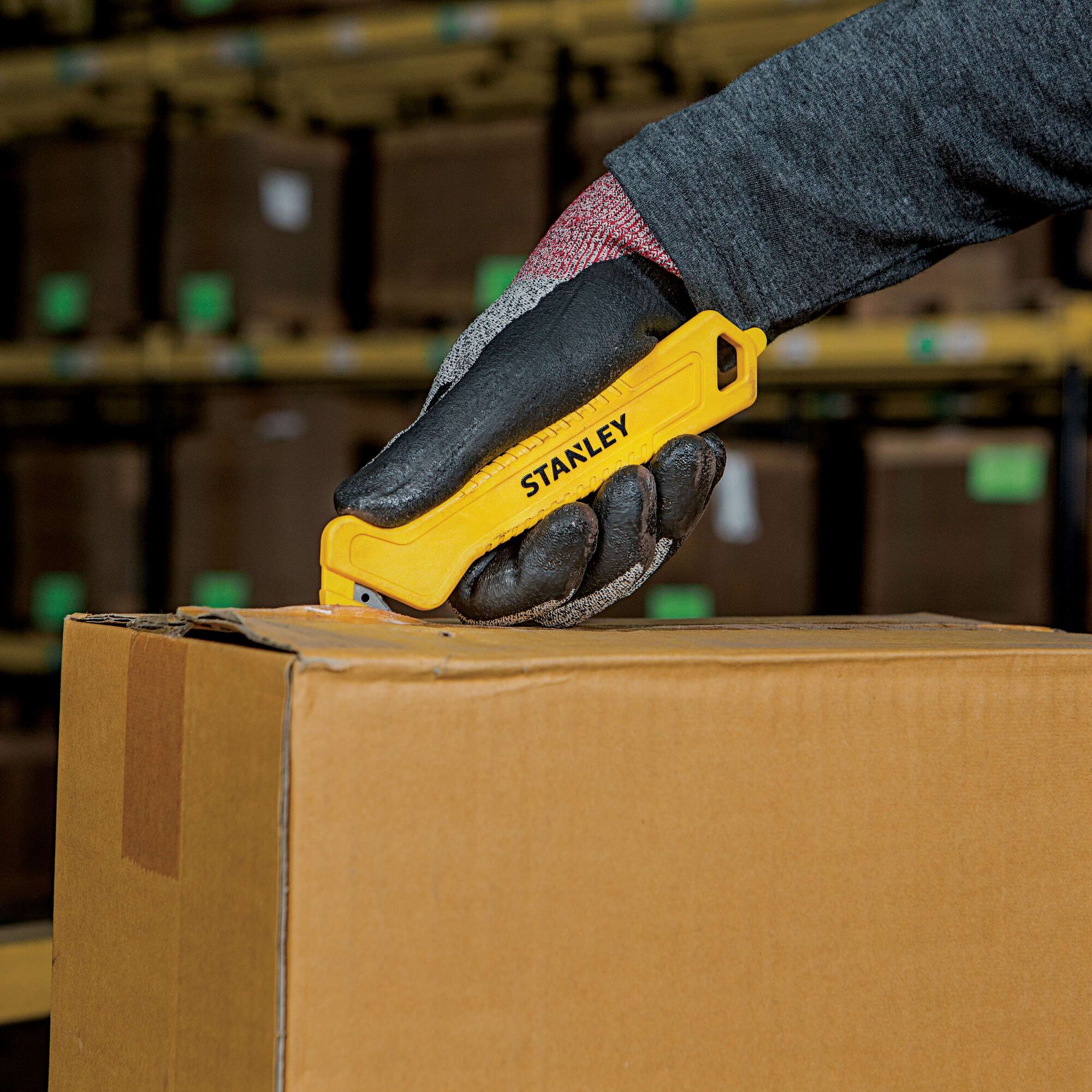 Single Sided Pull Cutter being used for opening package.