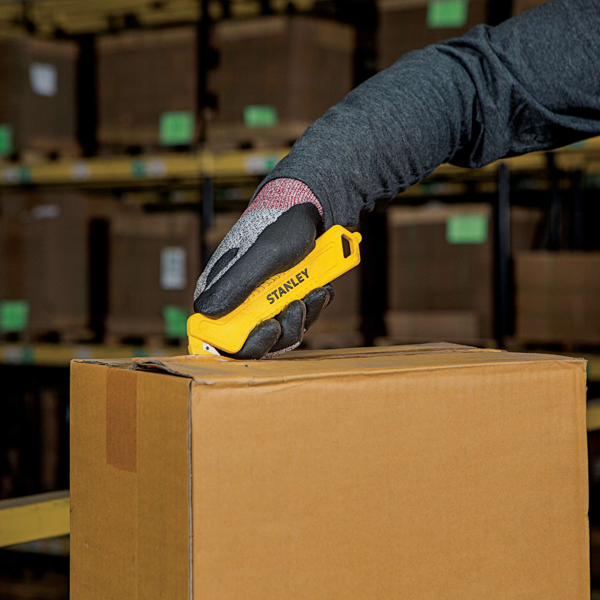 Single Sided Pull Cutter being used for opening box.