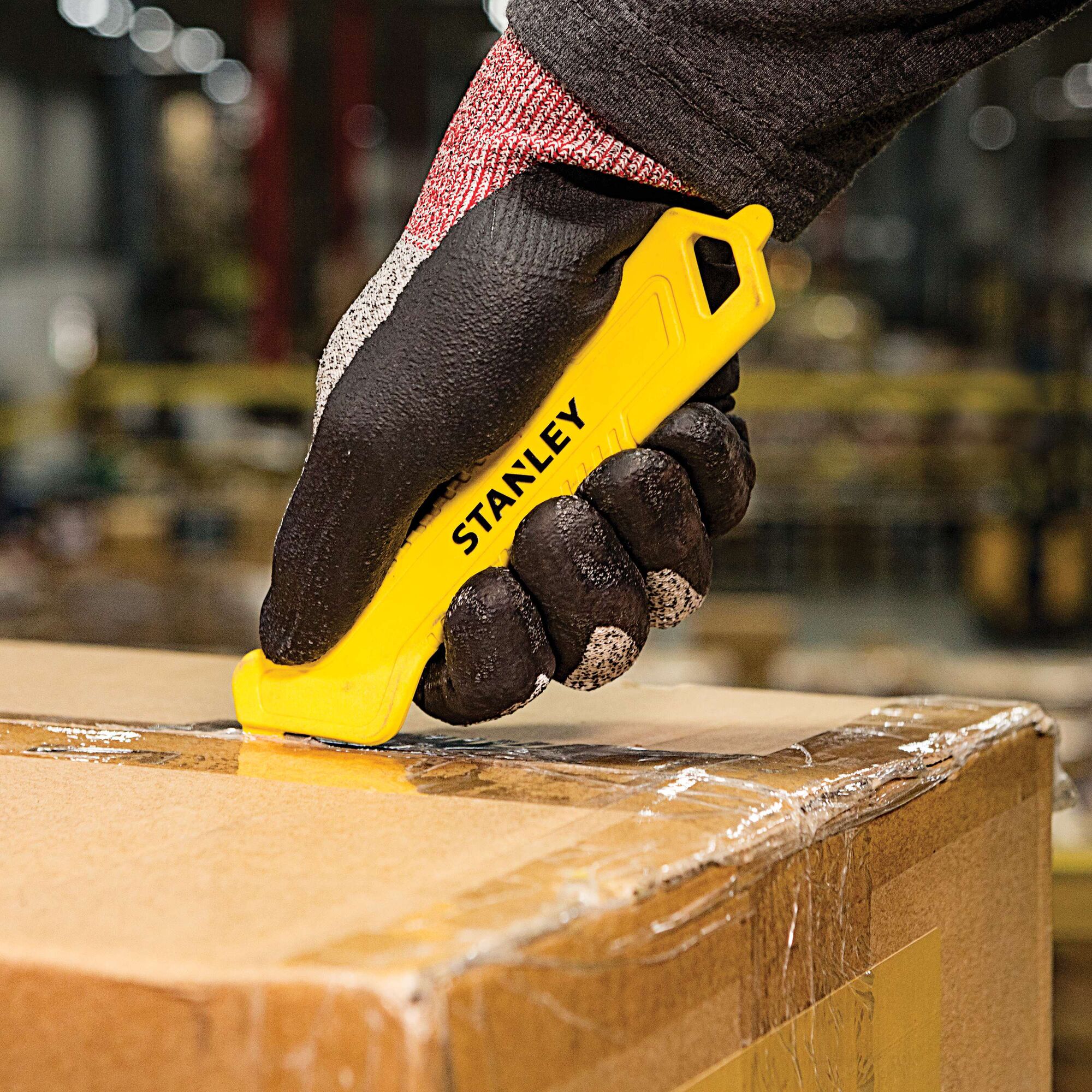 Single Sided Pull Cutter being used for opening of cardboard box.