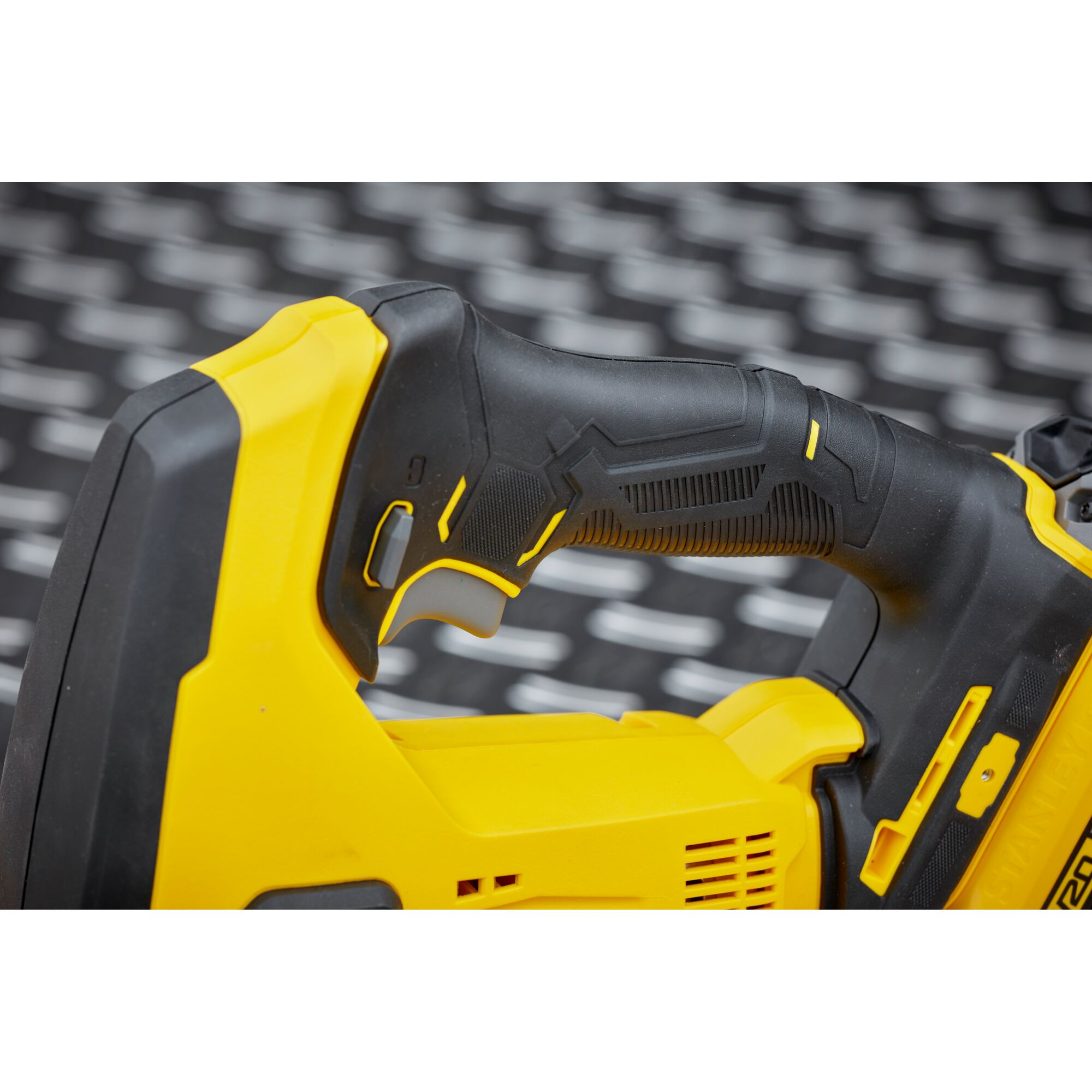 STANLEY SCJ600B power tool handle close-up, yellow and black ergonomic grip.