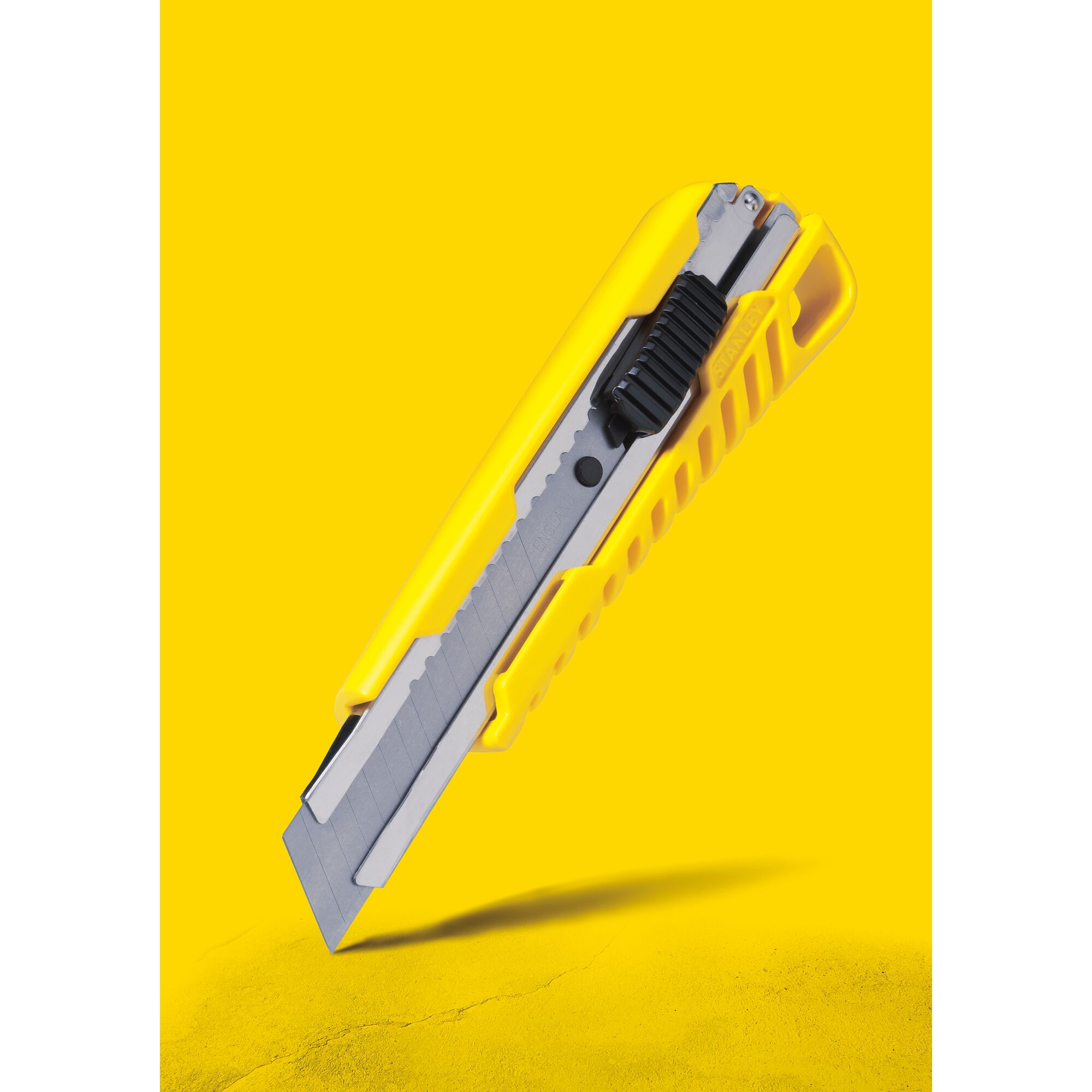 STANLEY STHT10276-8 utility knife, yellow and gray, angled side view, photography.