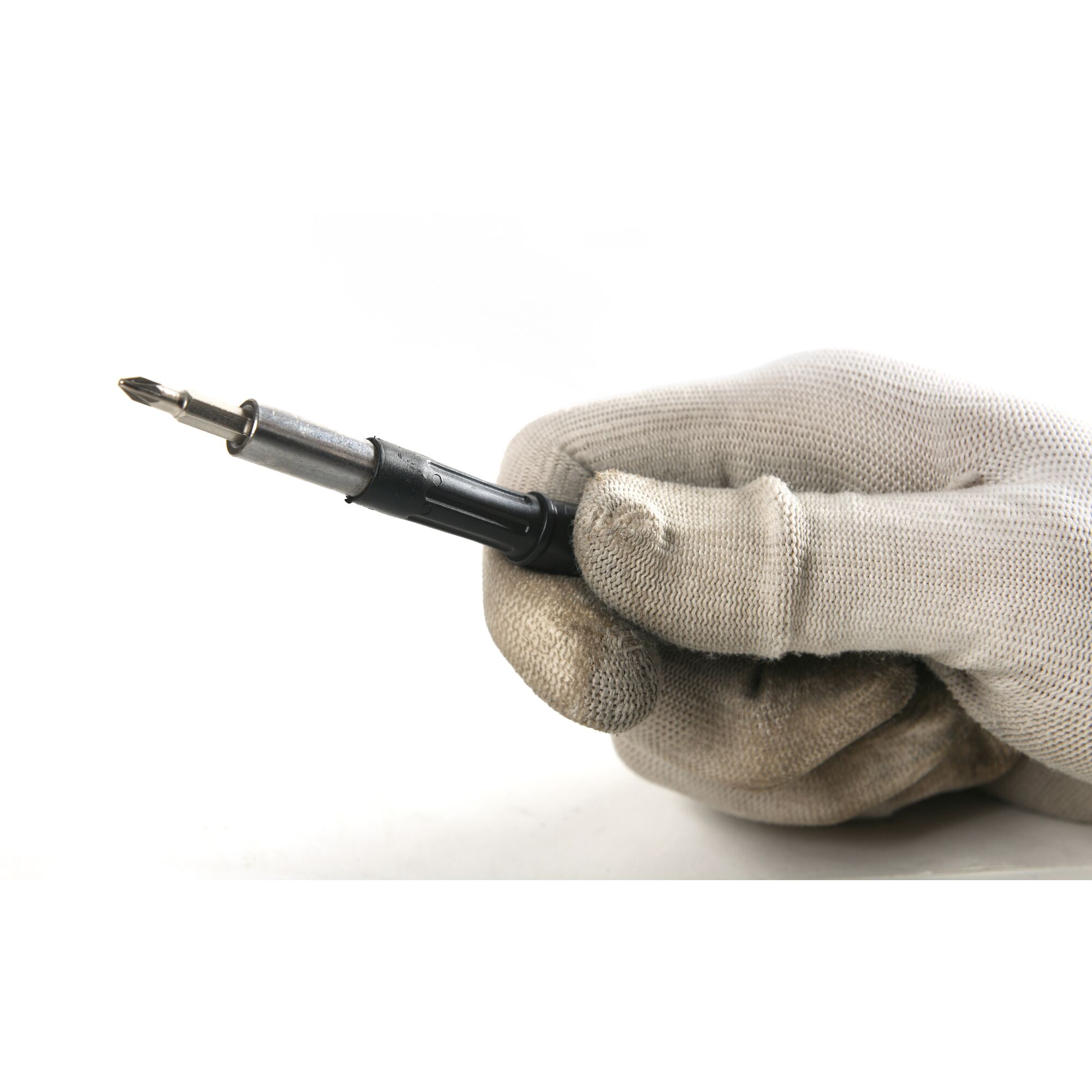 Photo of STANLEY STHT68010-8 screwdriver held by gloved hand, close-up on white background.