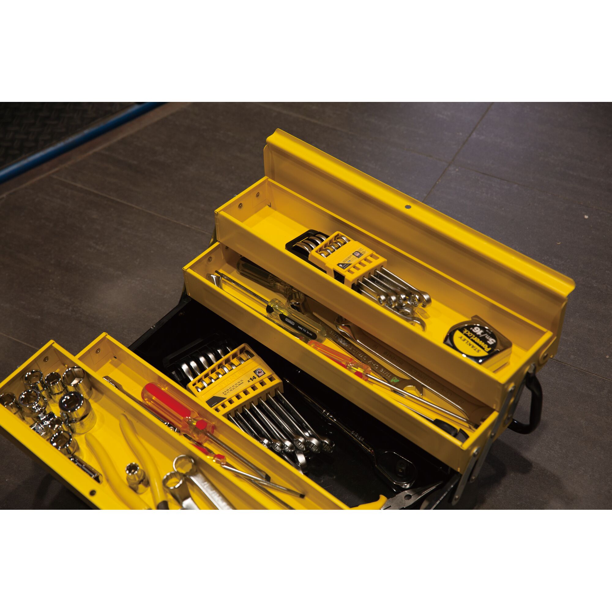 STANLEY STMT78098-8 photography of yellow metal toolbox with assorted hand tools on angled view.