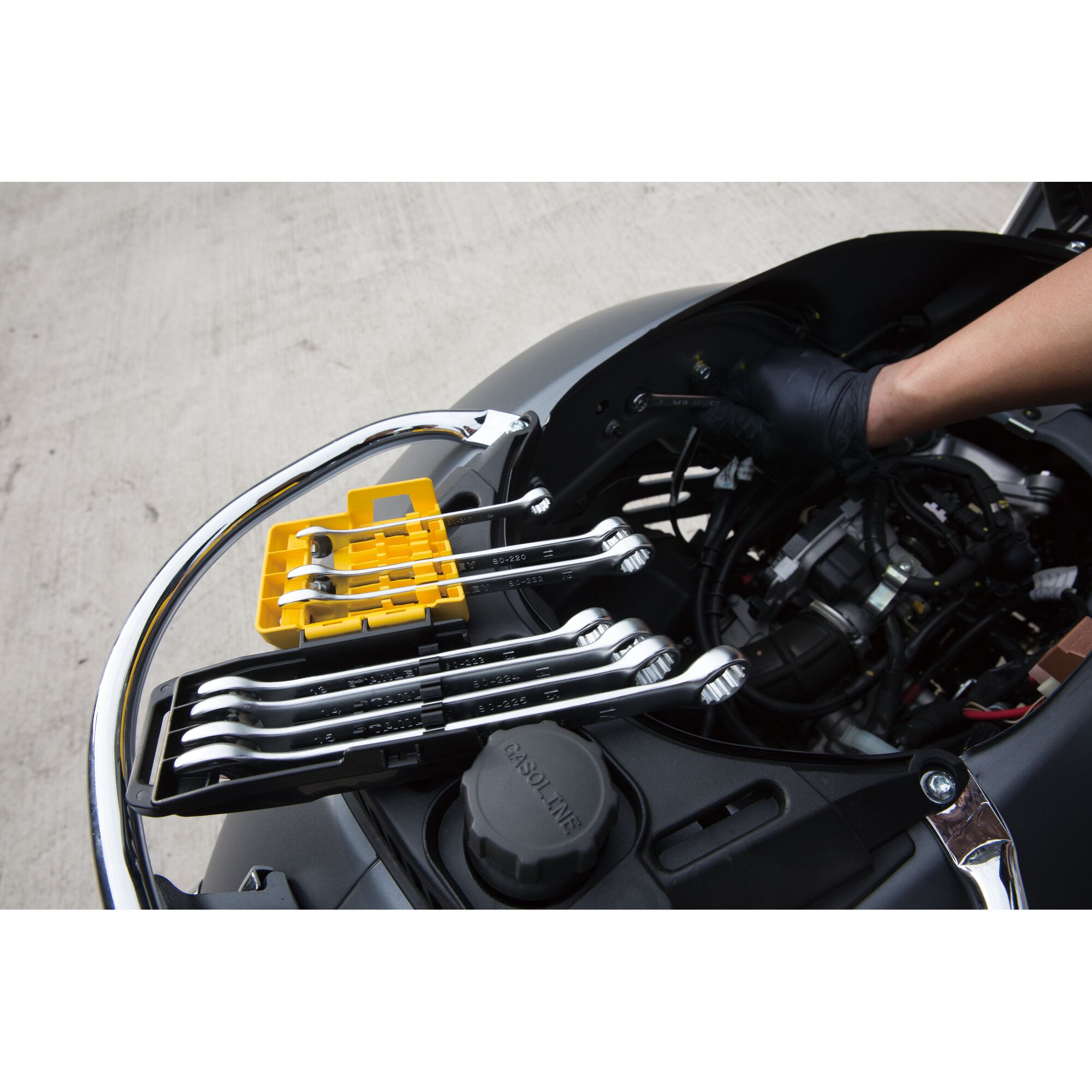 STANLEY STMT78099-8 wrench set with yellow and black tray on motorcycle engine during maintenance.